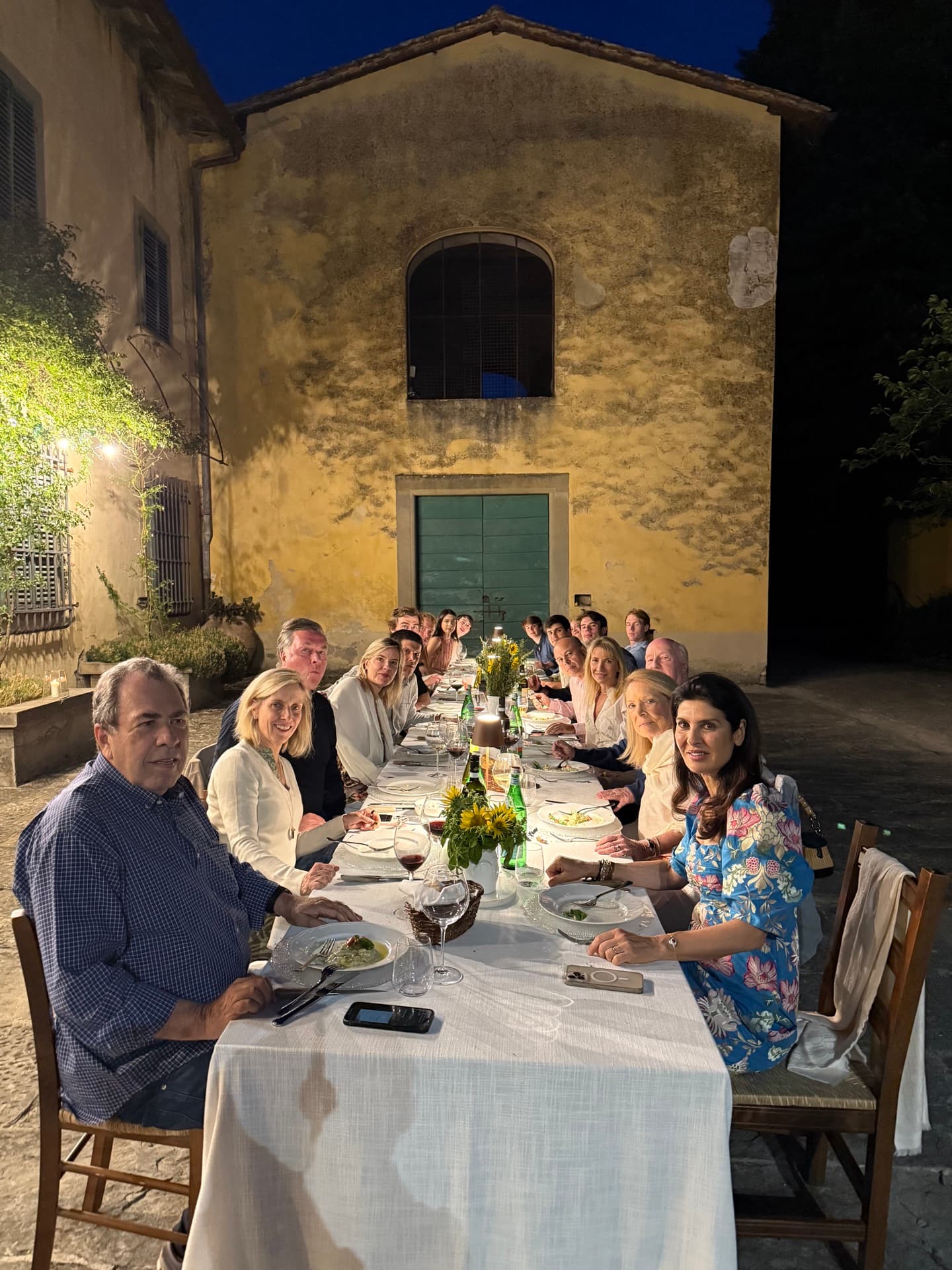 Family dinner outside the villa at night